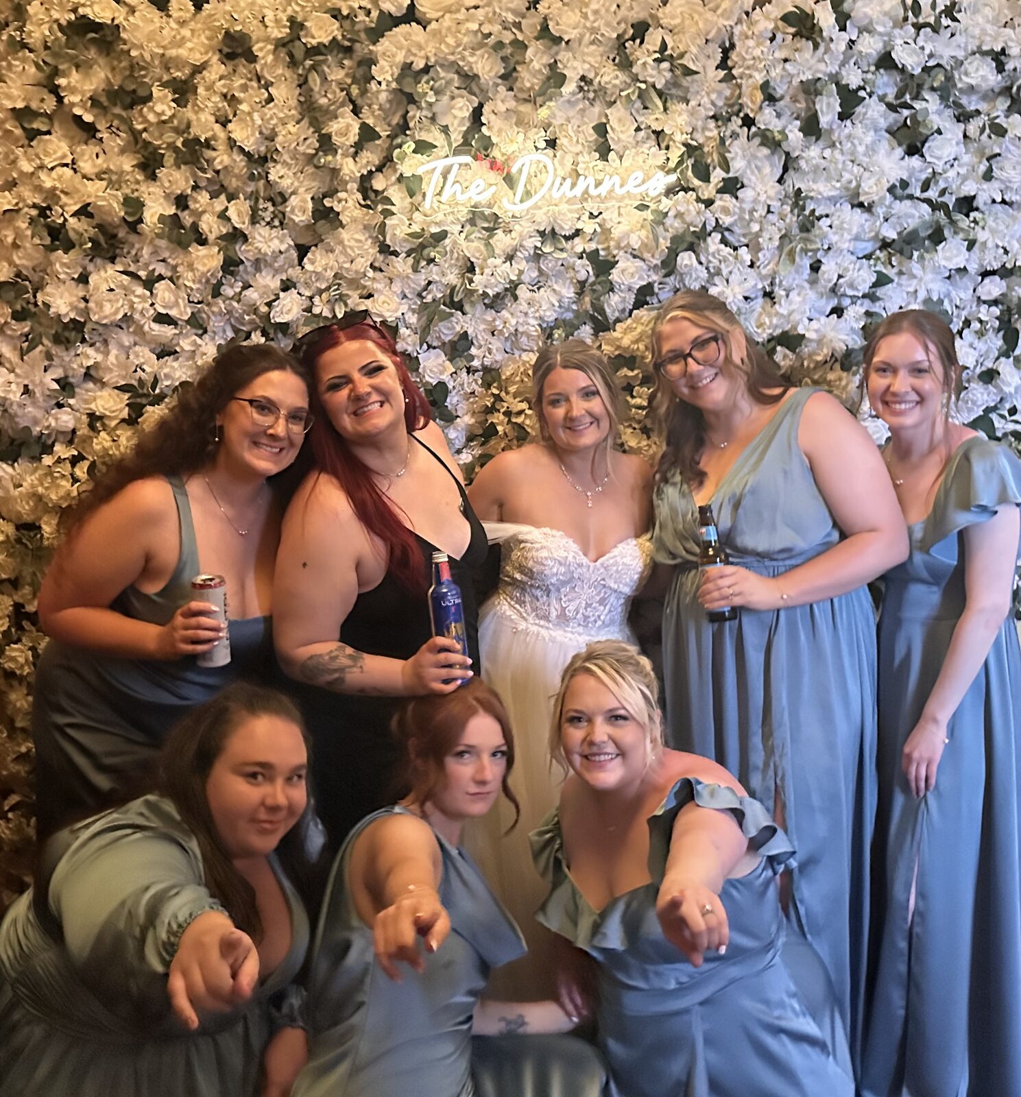 Bridal party celebrating at a La Rue Bloom flower wall rental
