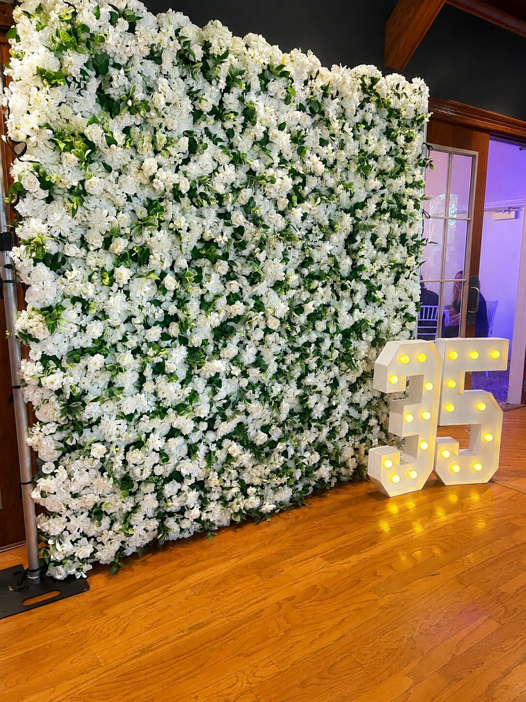 White flower wall rental with marquee numbers for a birthday celebration in Northern Michigan