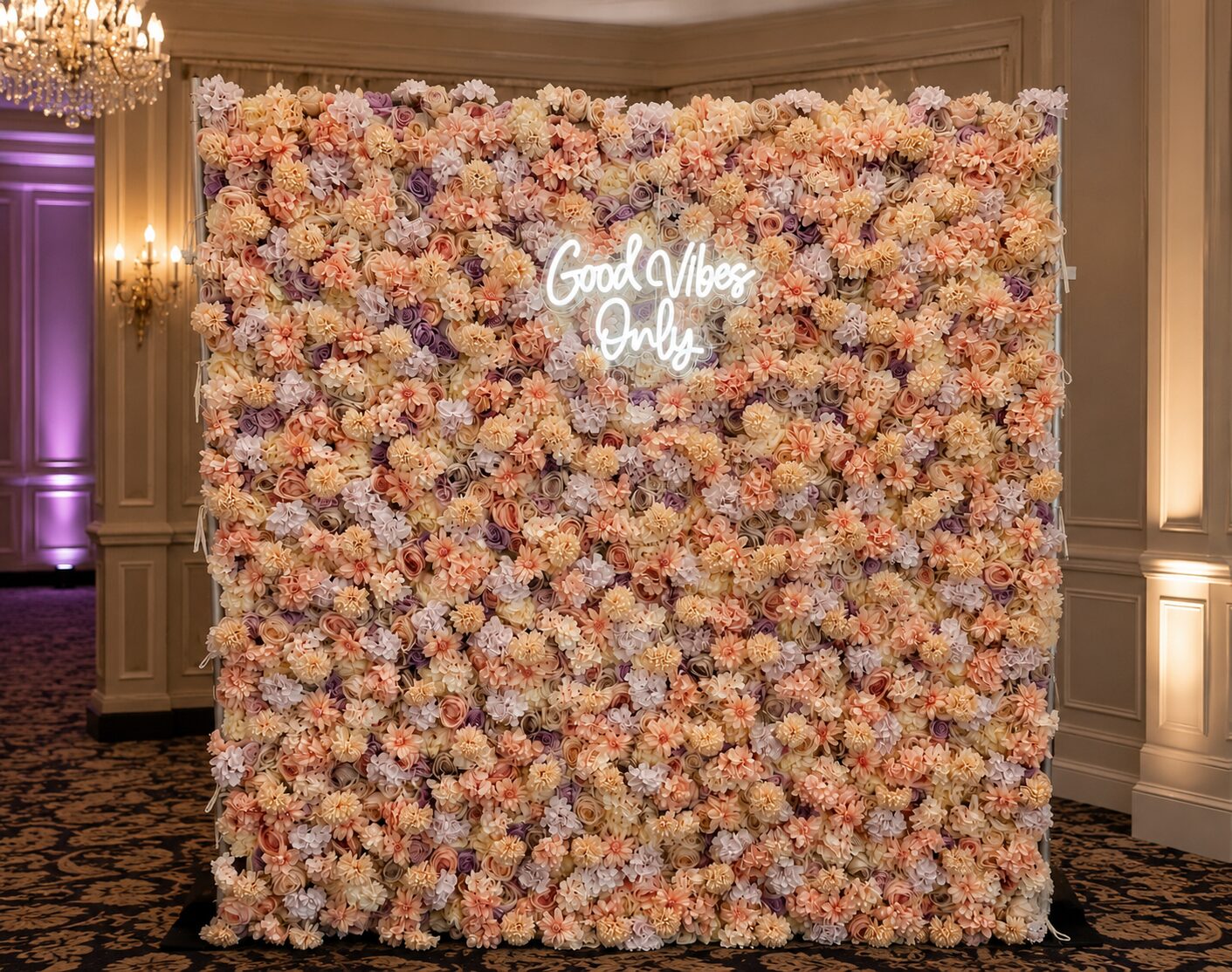 Blush and lavender flower wall rental with neon sign for an event